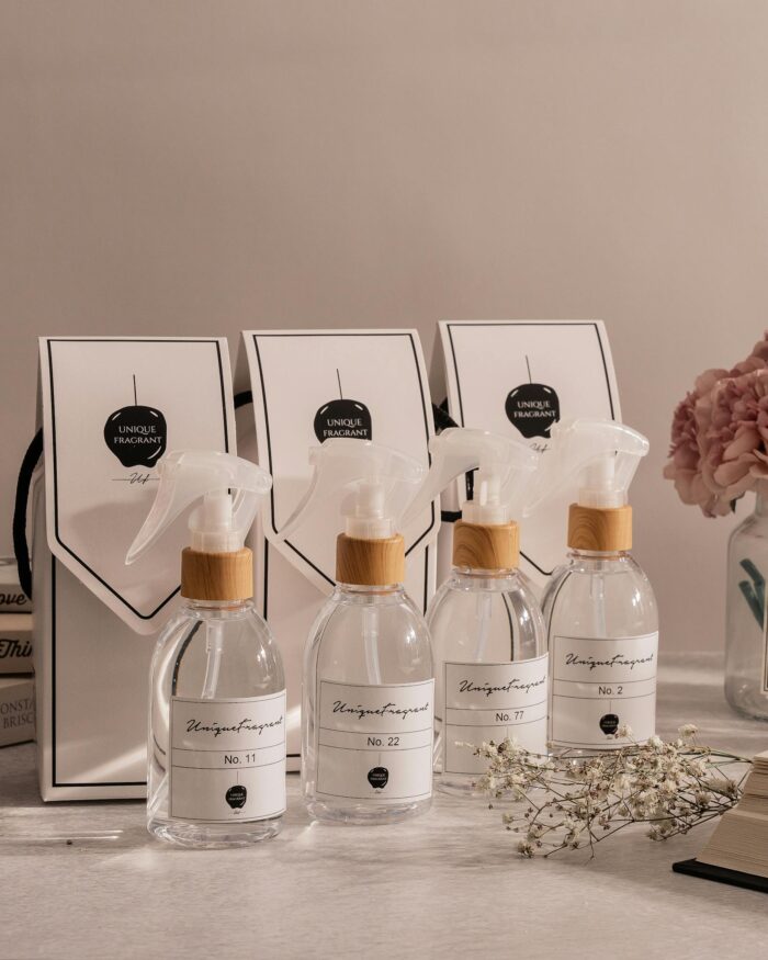 A collection of elegant fragrance bottles paired with gift bags, elegantly arranged on a table.