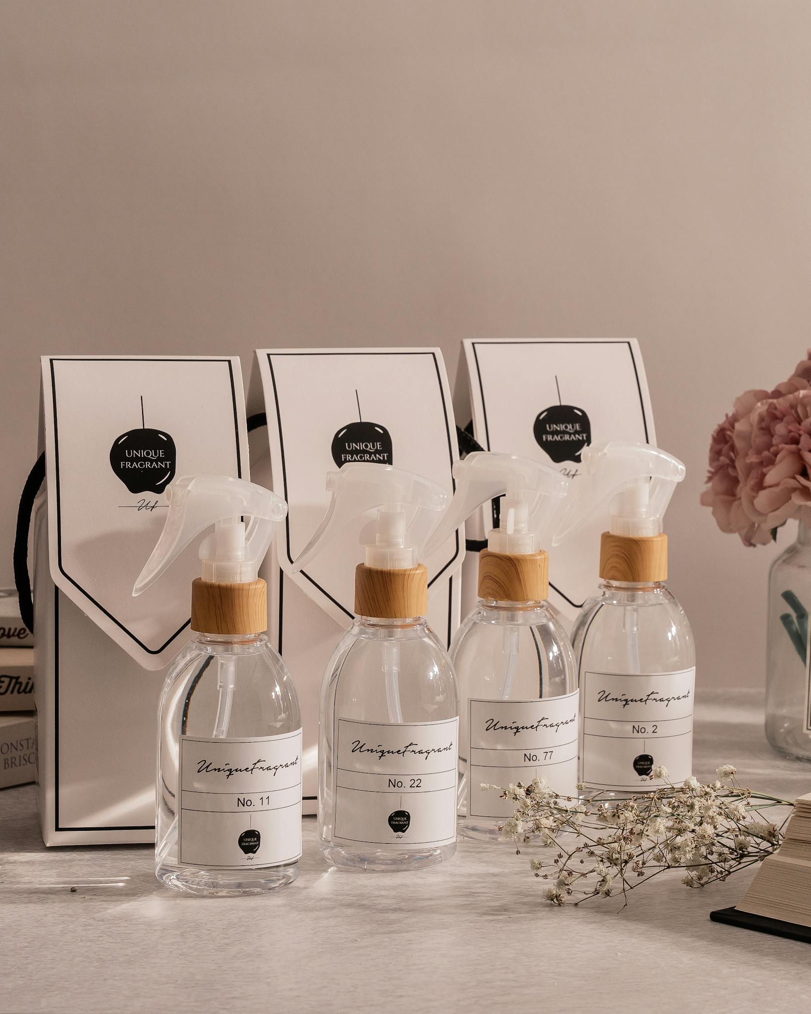 A collection of elegant fragrance bottles paired with gift bags, elegantly arranged on a table.